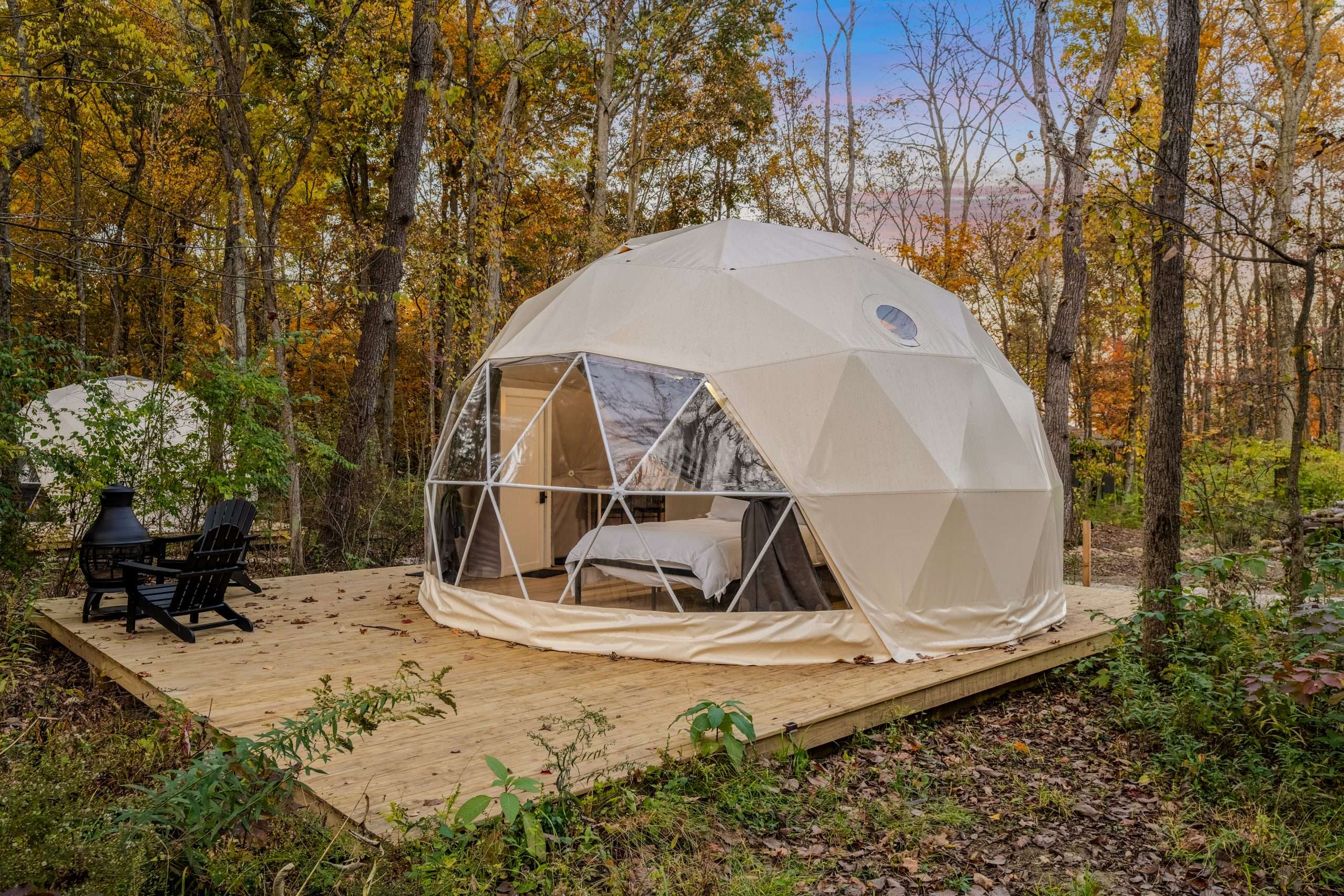 Retreat 21 Geodomes 01 Glamping geodome nestled in woodland surroundings under autumn foliage