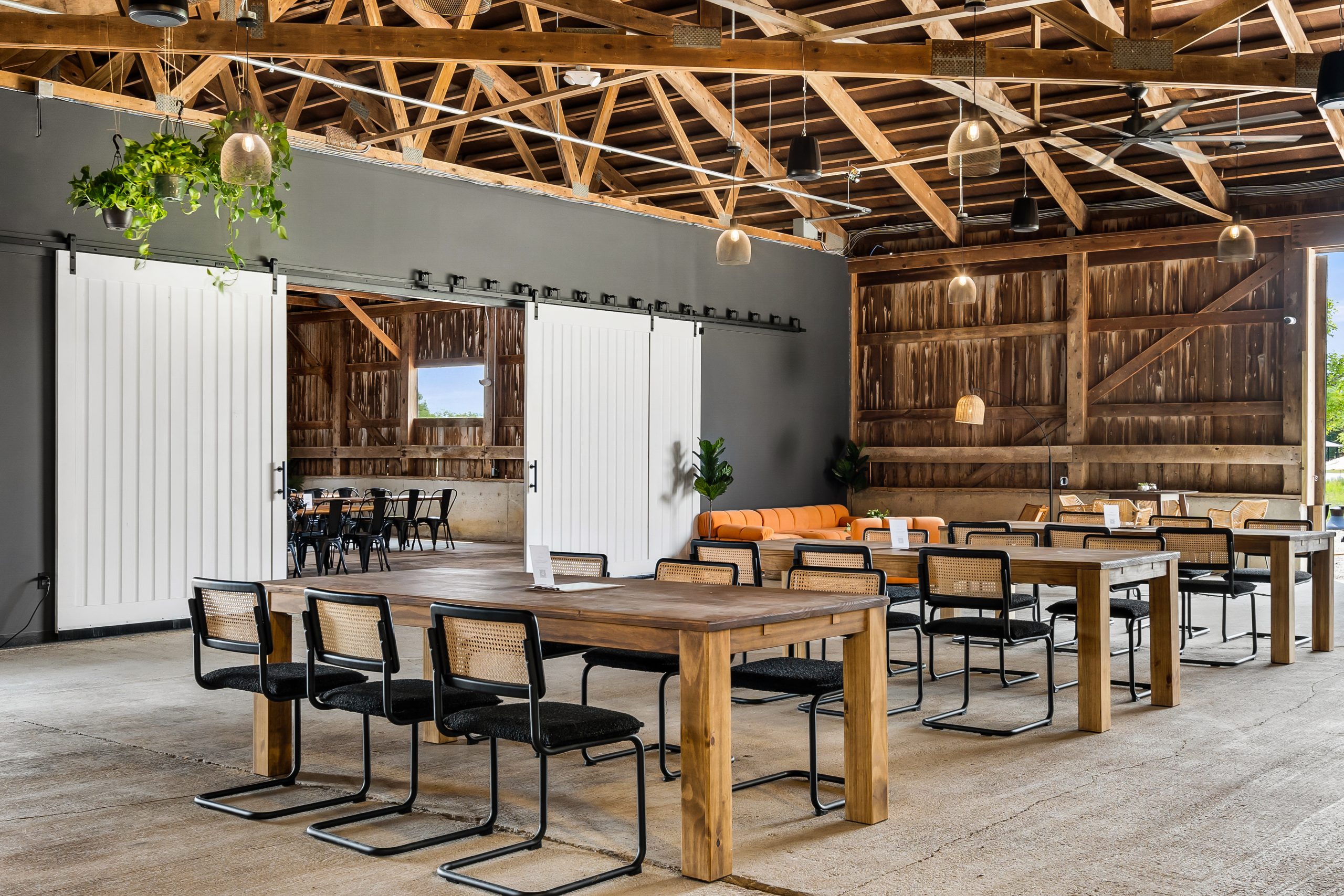 Taphouse Seating The Vineyard Room at The Taphouse with natural light, wood interiors, and tables set for wine tasting or private events