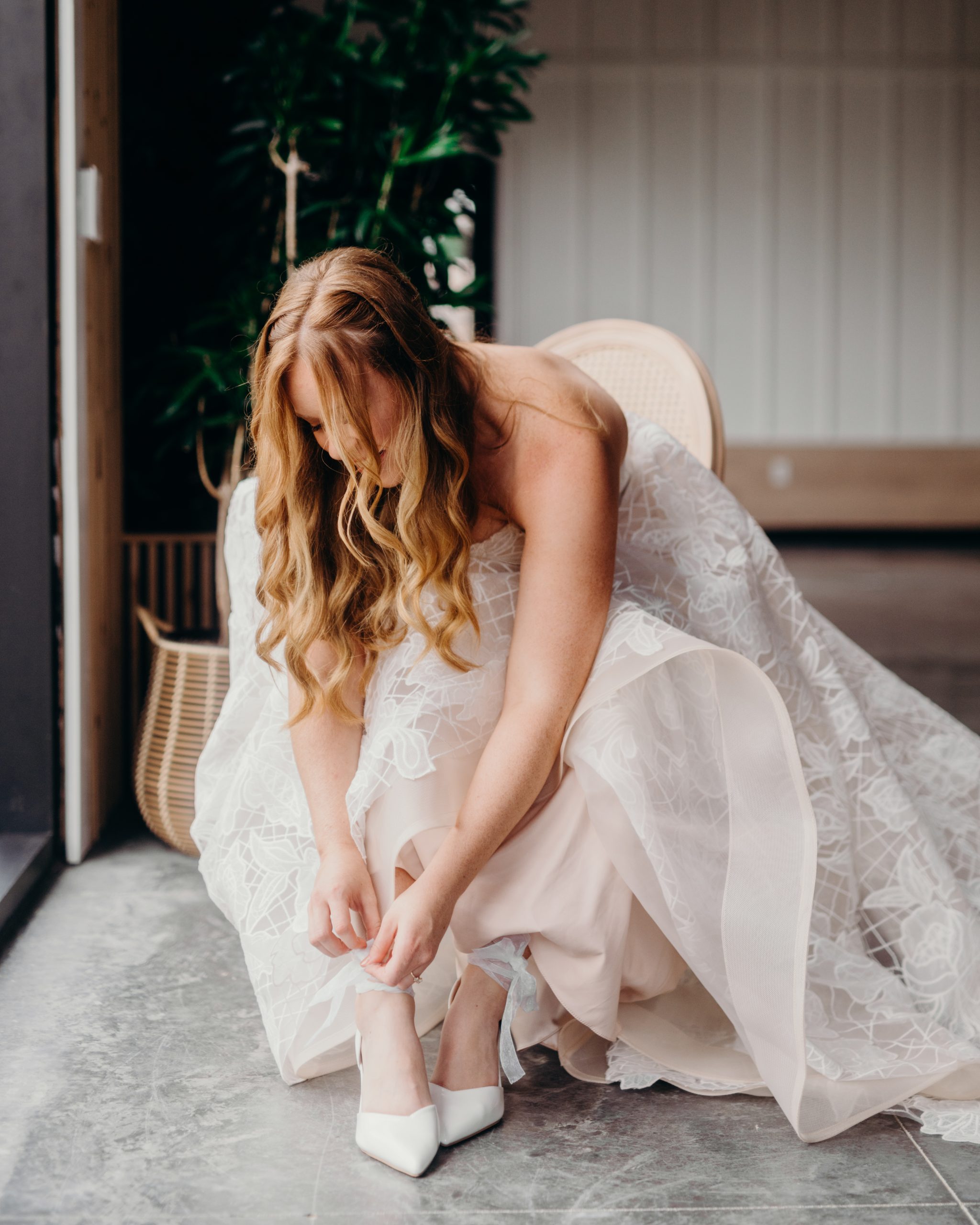 Bride preparing her shoe during wedding day getting-ready moments at Retreat 21 near Columbus, Ohio