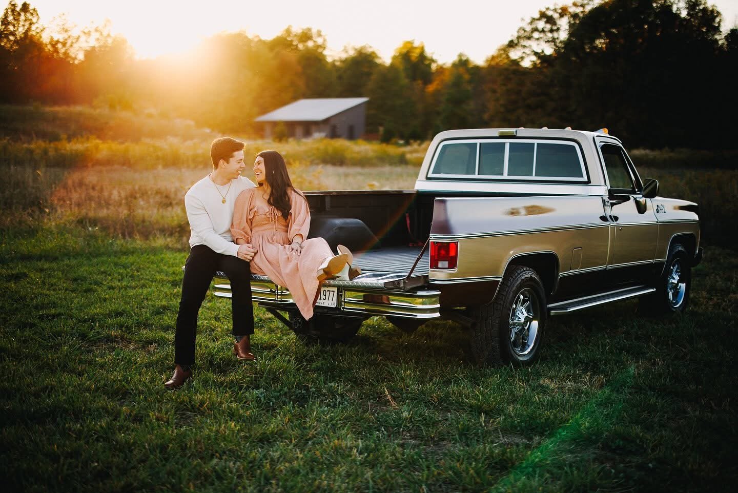 Bride and groom sitting in a pickup truck at sunset at Retreat 21 near Columbus, Ohio