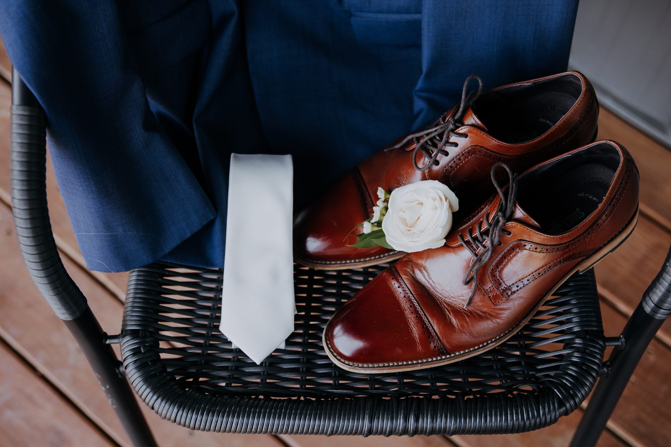 Groom’s shoes and tie arranged on a chair during wedding prep at Retreat 21 near Columbus, Ohio