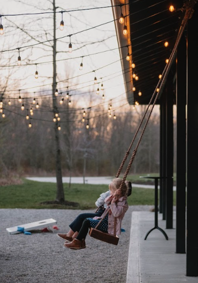 Woman swinging outdoors with her child at Retreat 21 near Columbus, Ohio
