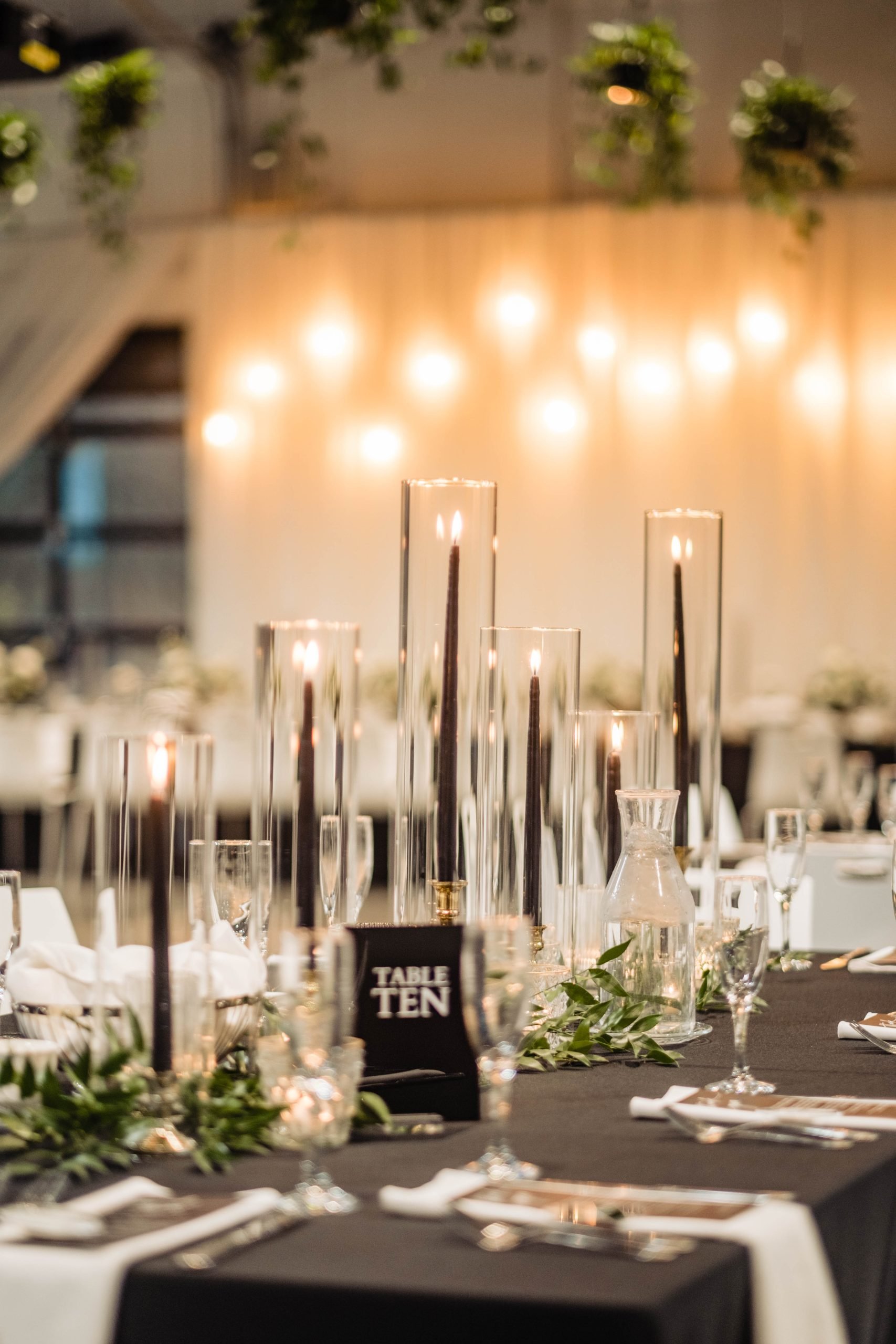 Candlelit table arrangement with floral decor at indoor wedding reception at Retreat 21 near Columbus, Ohio