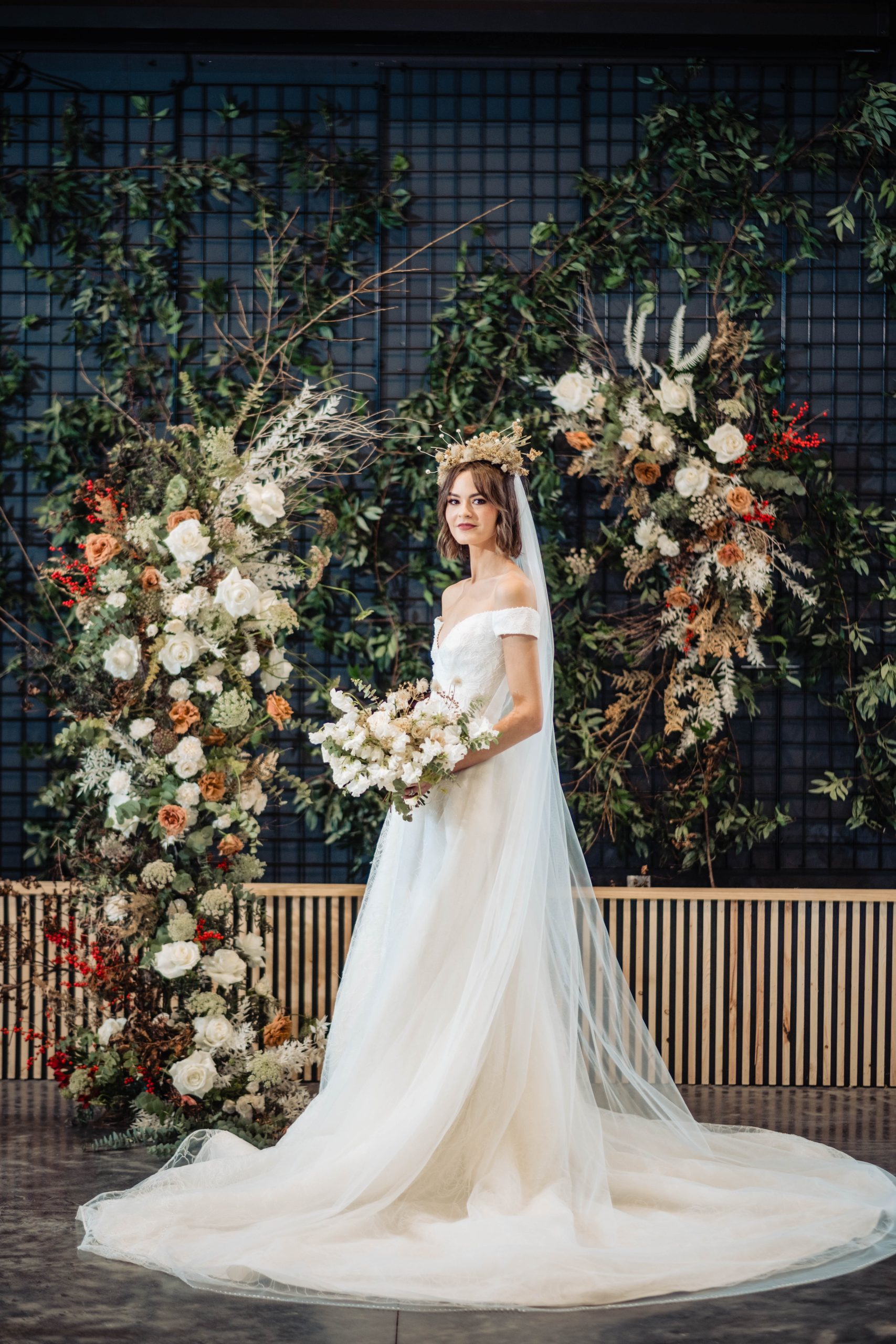 Smiling bride surrounded by flowers inside wedding venue at Retreat 21 near Columbus, Ohio