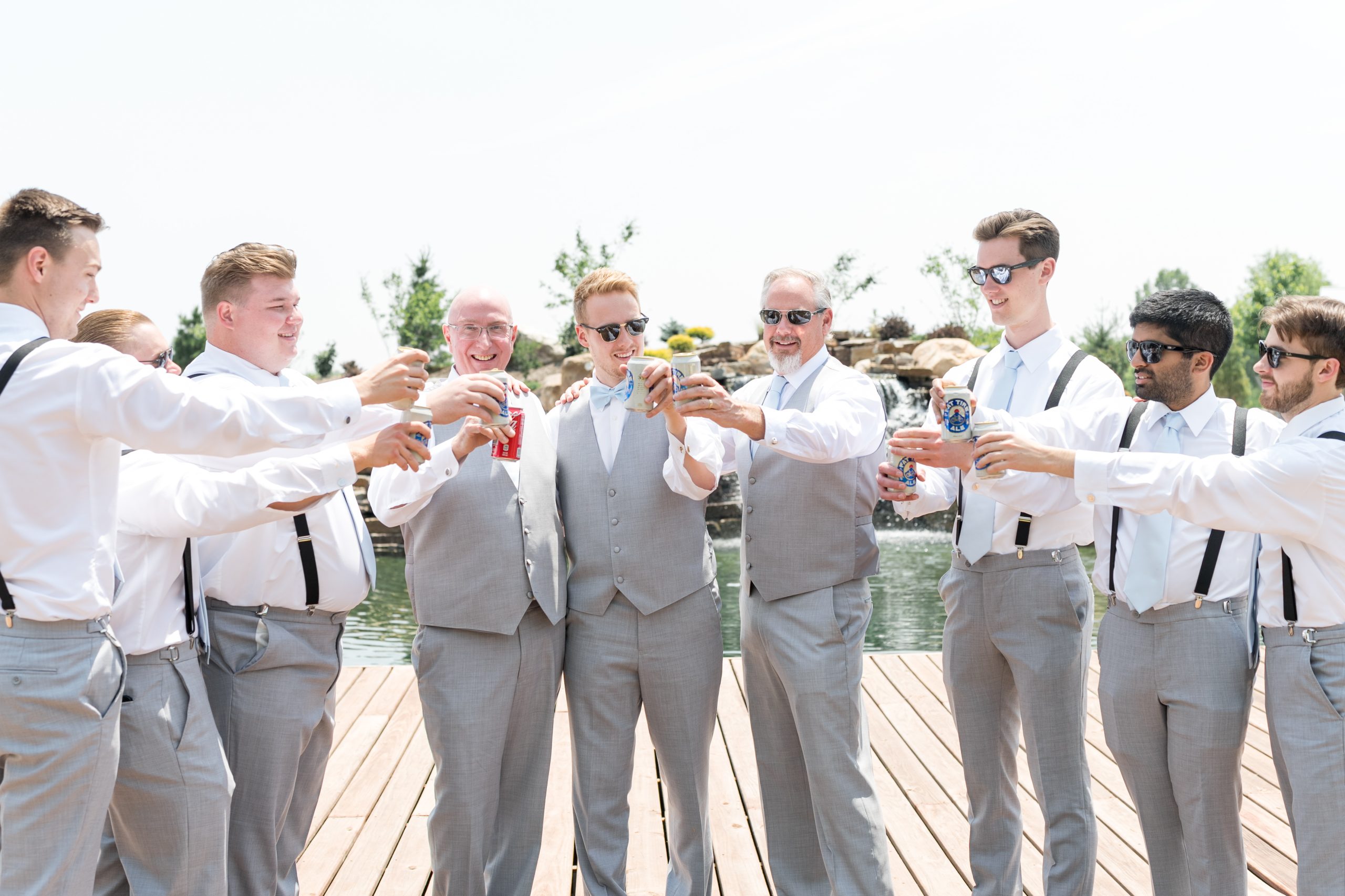 Groomsmen dressed up and raising a toast outdoors at Retreat 21 near Columbus, Ohio