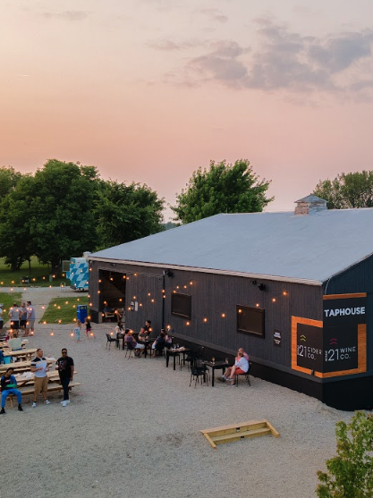 Aerial view of outdoor reception area with string lights, tables, and event building at Retreat 21 near Columbus, Ohio
