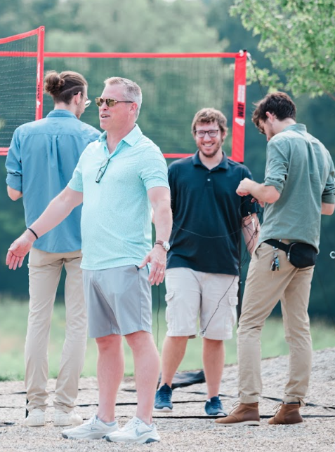 Guests smiling and enjoying a casual weekend outdoors at Retreat 21 near Columbus, Ohio