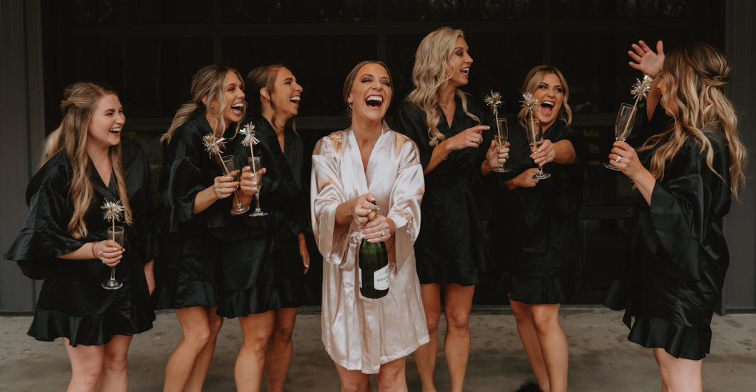 Women in robes laughing together during wedding preparation at Retreat 21 near Columbus, Ohio