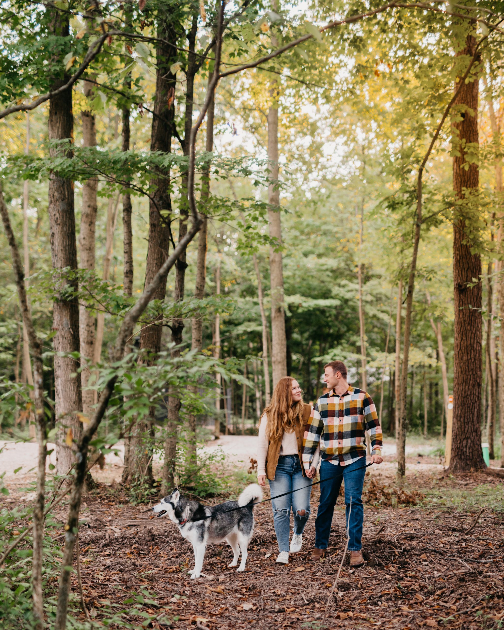Man and woman with their dog in the woods at Retreat 21 near Columbus, Ohio