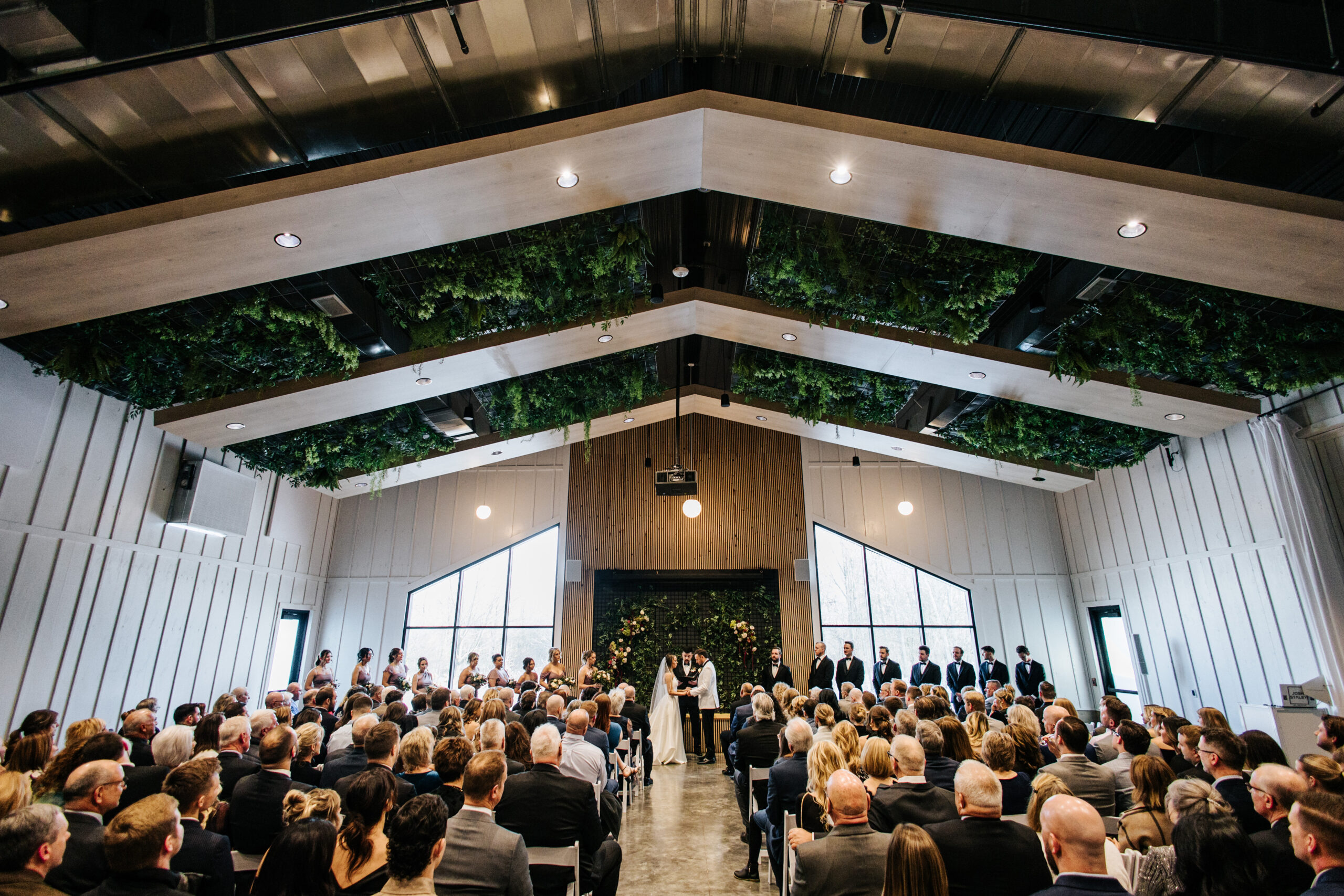 Nagel Wedding Indoor wedding ceremony setup with white chairs and large windows in an empty room at Retreat 21 near Columbus, Ohio