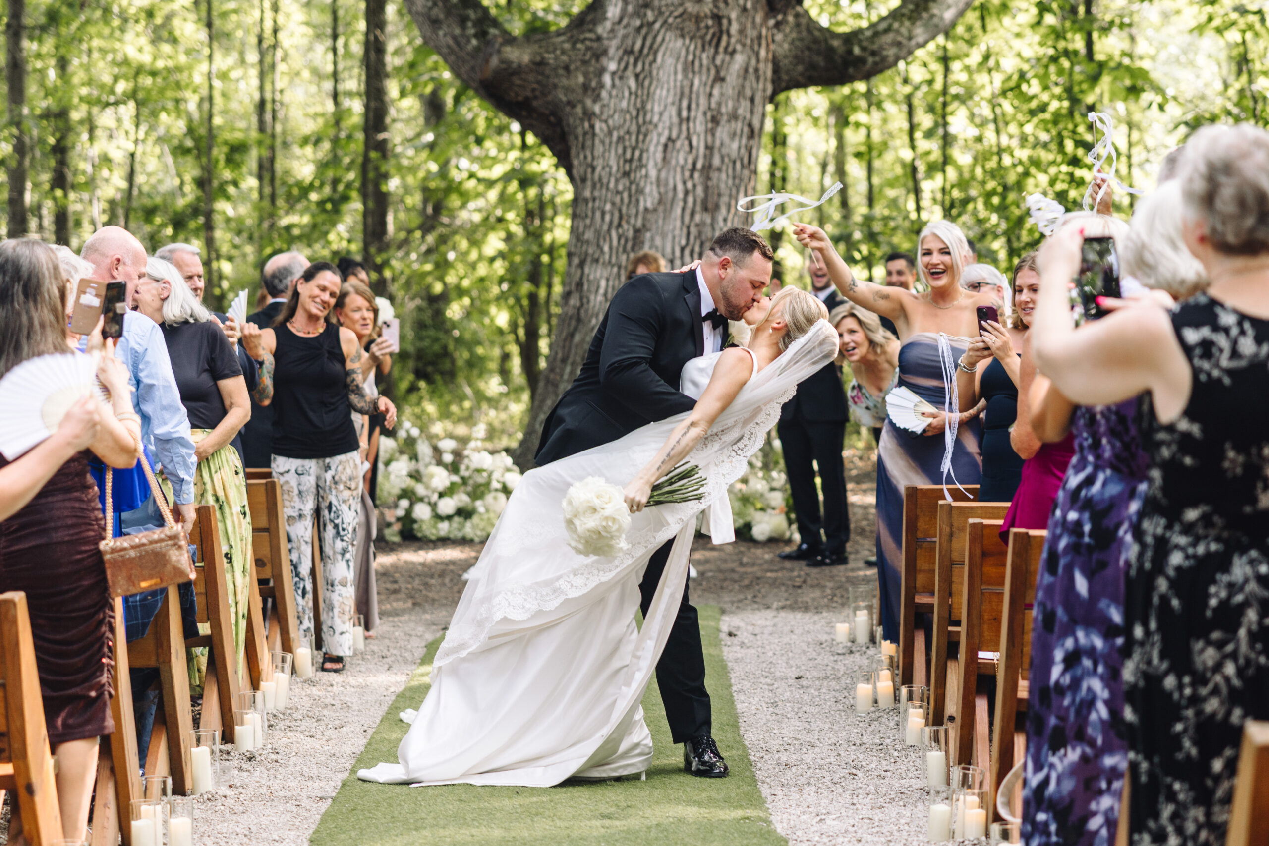 1W7A3811 Bride and groom kiss on a dock by the water at Retreat 21, romantic outdoor wedding moment near Columbus, Ohio