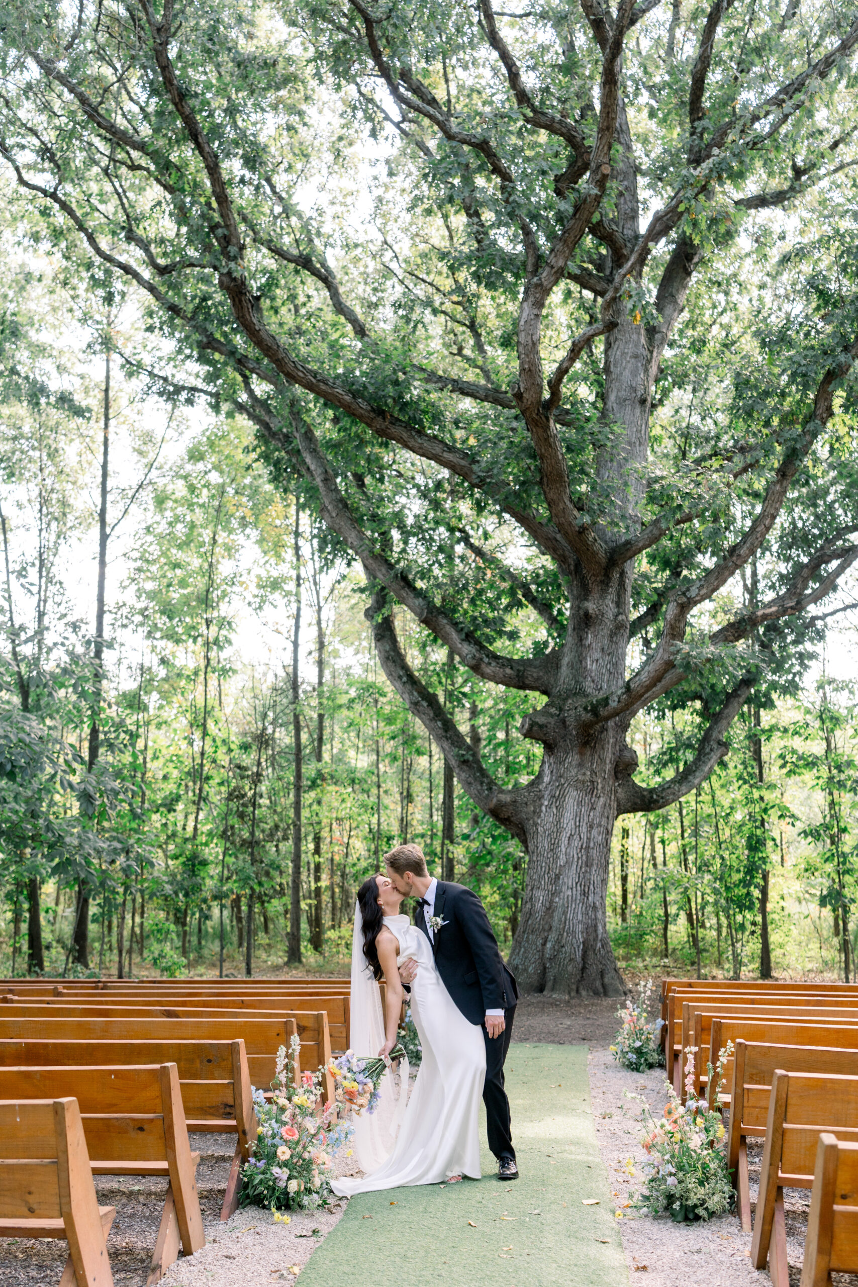 QALP-486 Two children holding hands as they walk down the aisle during outdoor wedding ceremony at Retreat 21 near Columbus, Ohio