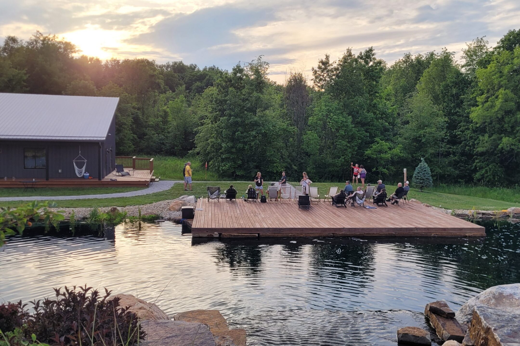 A corporate meeting in Marysville, Ohio at Retreat 21 at a waterfront deck doing a team building wellness activity